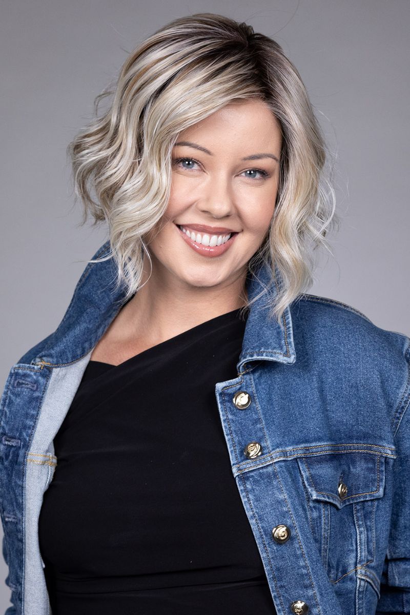 Clare Wig by Belle Tress in Butterbeer R 10/60/88+8 | Butterbeer Root hair color is an inviting blend that exudes a cozy, radiant charm. The roots feature soft dimensions of brown base with a touch of depth, giving a natural and lived-in look. This transitions smoothly into a buttery blonde, infused with creamy honey and toffee tones that shimmer like the frothy top of a freshly poured butterbeer.